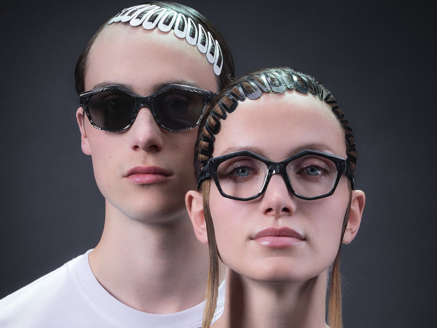 Alain Mikli campaign portrait of two models in black and white wearing graphic Alain Mikli frames