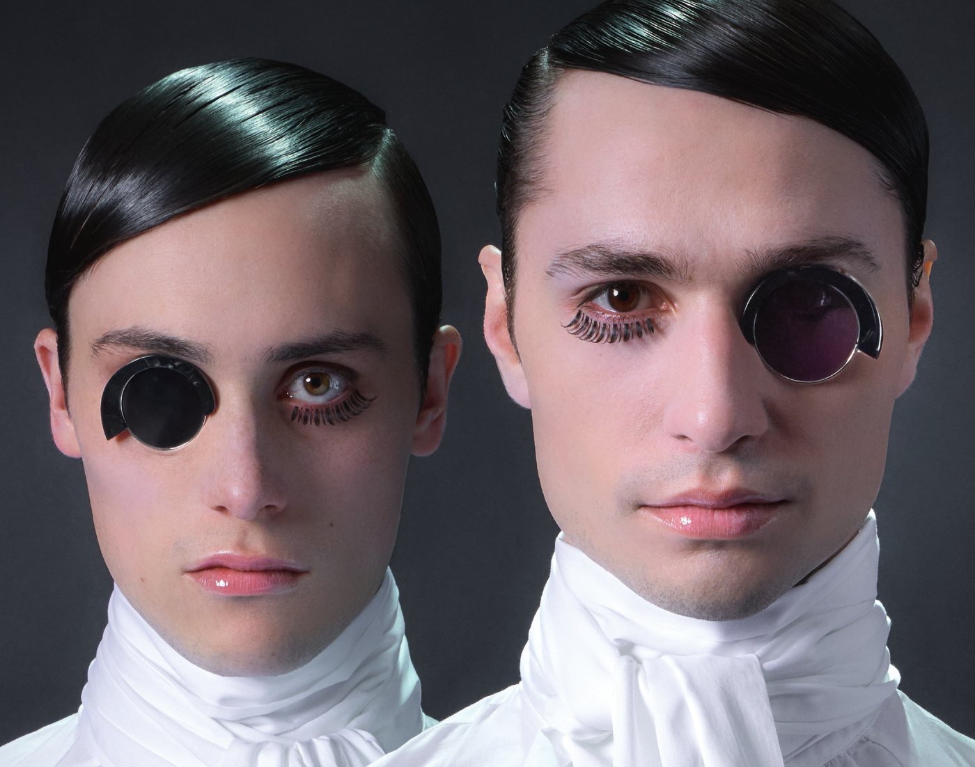 Alain Mikli campaign portrait of two models in white wearing Alain Mikli monocle frames